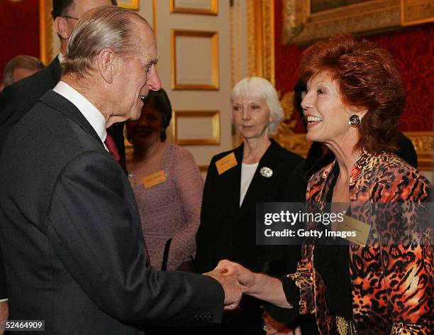 Britain's Duke of Edinburgh, Prince Philip meets actress Rula Lenska at a reception for the Women's Royal Voluntary Service at St James's Palace on...