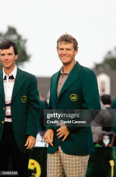 Sandy Lyle of Scotland is presented with the green jacket by Larry Mize of USA after the final round of the Masters, held at The Augusta National...