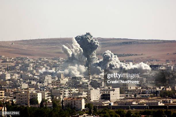 Flames rise from an explosion in the Syrian town of Kobane, also known as Ain al-Arab, after a US-led coalition airstrike as it seen from the Turkish...