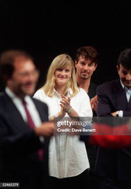 Singer Michael Jackson signs autographs for fans as wife Debbie Rowe looks on, on July 10, 1997 in Sheffield, England.