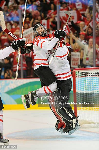 Team Canada captain Haley Wickenheiser jumps on goalie Shannon Szabados after beating The United States to win the gold medal in hockey at Canada...