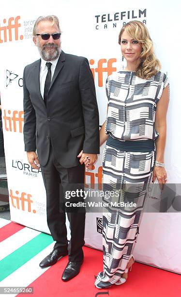 Kevin Costner and wife Christine Baumgartner arrive at the 'Black and White' premiere during the 2014 Toronto International Film Festival at Roy...