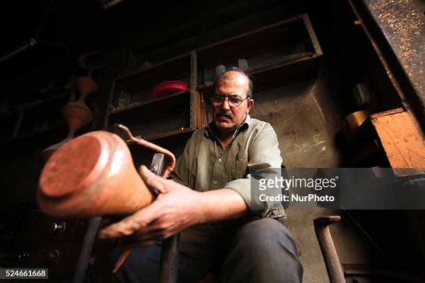 Gaza, Palestine on June 20, 2015 Mohammed Abdo in 53 -year-old works copper industry inherited this profession from his father for nearly 40 years ....
