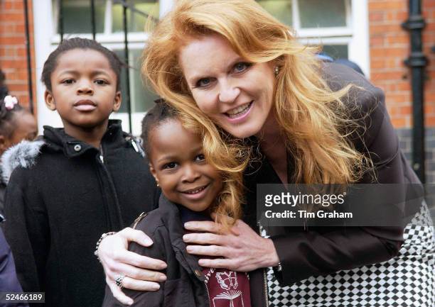 Sarah Duchess of York hugs one of the pupils at Oliver Goldsmith School in Peckham, the former school of Damilola Taylor, where the Duchess will see...