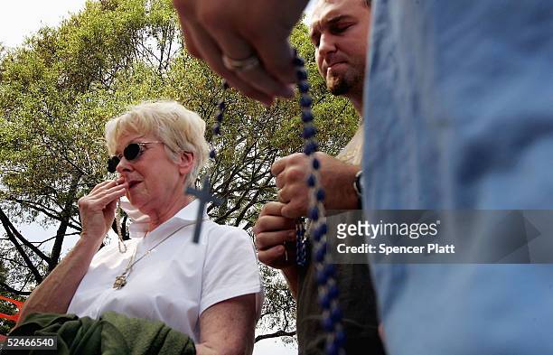 Supporters of brain-damaged Florida woman Terri Schiavo pray in front of the Woodside Hospice where Schiavo is being cared for March 22, 2005 in...