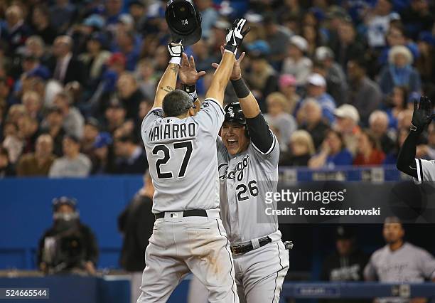 Dioner Navarro of the Chicago White Sox is congratulated by Avisail Garcia after hitting a two-run home run in the seventh inning during MLB game...