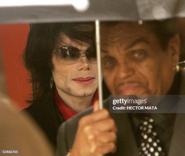 Pop star Michael Jackson departs the Santa Barbara County Courthouse with his father Joe 22 March 2005 in Santa Maria, California. AFP...