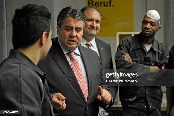 Energy Minister Sigmar Gabriel departs after visiting a cabinet-making tradecrafts exposure program for migrants and refugees at the Arrivo center on...