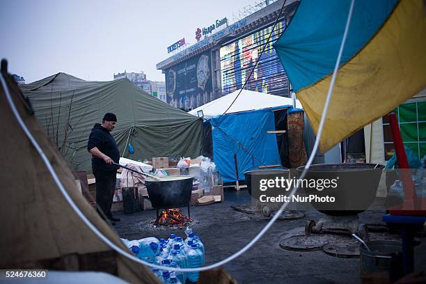 Ukrainian man serves soup at a camp set up by opposition demonstrators on Kiev's Independence Square on February 7, 2014. The Euromaidan is a wave of...