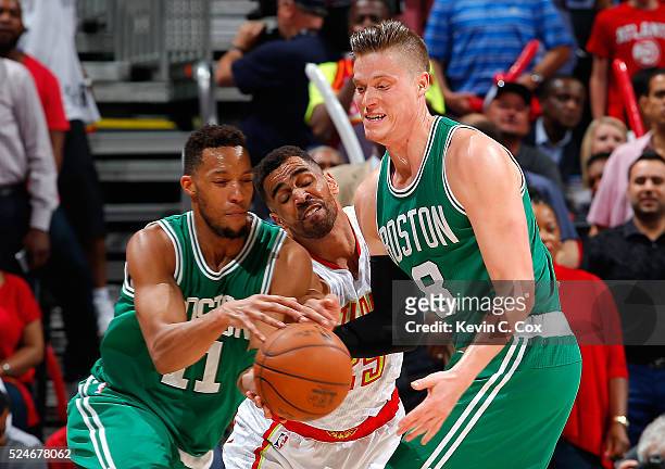 Thabo Sefolosha of the Atlanta Hawks reaches for a steal as Jonas Jerebko hands the ball off to Evan Turner of the Boston Celtics in Game Five of the...