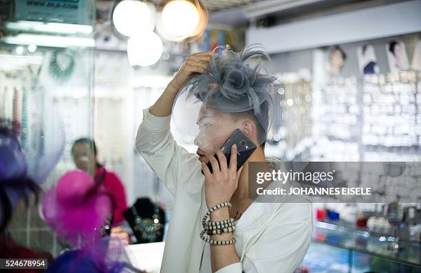 This picture taken on April 2 shows Yu Xiaoyang - who uses the stage name Xiao Bai meaning "Little White" - trying on a hat during a shopping tour...