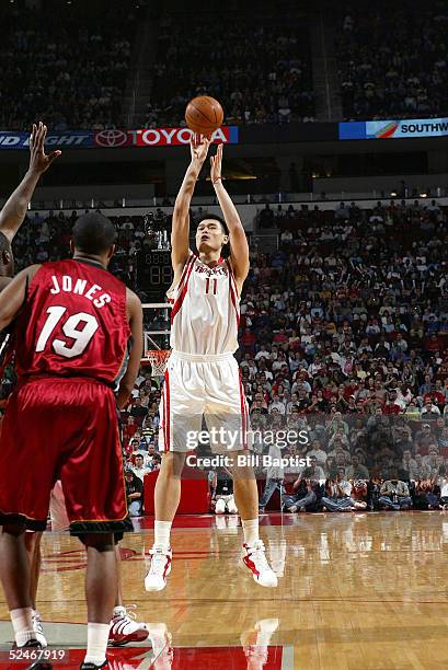 Yao Ming of the Houston Rockets shoots in front of Damon Jones of the Miami Heat on March 22, 2005 at the Toyota Center in Houston, Texas. NOTE TO...