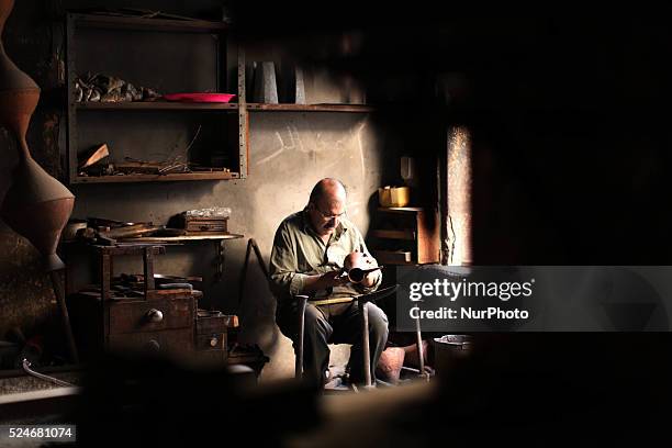 Gaza, Palestine on June 20, 2015 Mohammed Abdo in 53 -year-old works copper industry inherited this profession from his father for nearly 40 years ....