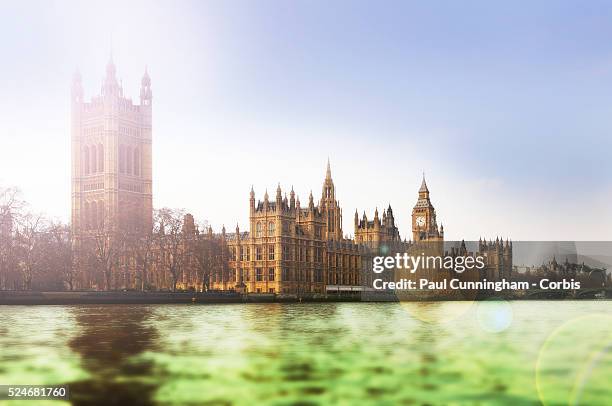 The Iconic Houses of Parliament and the Big Ben clock viewed from the water, standing on the banks of the river Thames in London. 23 March 2012 ---...