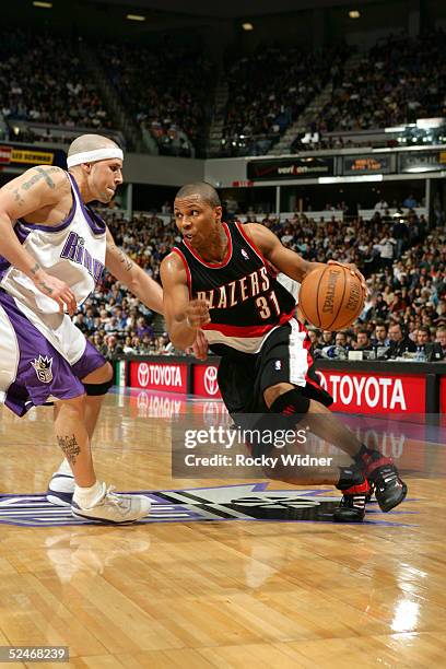 Rookie, Sebastian Telfair of the Portland Trail Blazers, drives to the basket around Mike Bibby of the Sacramento Kings on March 22, 2005 at Arco...