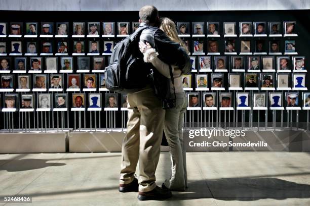 Rodney Nightingale and his wife, Towina Nightingale of Highland, Indiana embrace after seeing their son's portrait among the "Faces of the Fallen;...