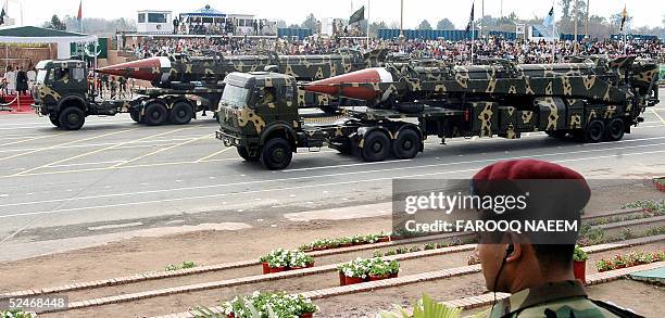 Pakistani commando looks on as Ghauri intermediate-range missiles capable of carrying nuclear warhead are transported on launchers during the...