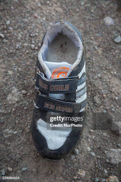 Boys sneaker with velcro closures found near Eftalou on the island of Lesbos. Shoes found on the beaches and around the Greek island where thousands...