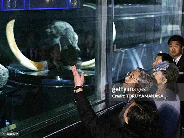 Accompanied by Empress Michiko and Crown Prince Naruhito , Japanese Emperor Akihito receives an explanation from Professor Naoki Suzuki about the...