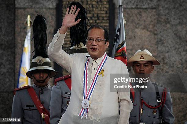 Philippine President Benigno Aquino III waves to the crowd during a ceremony marking Filipino nationalist Andres Bonifacio's 150th birth anniversary...