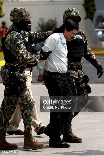 Mexican Navy soldiers escort Joaquin Guzman Loera , alias "El Chapo Guzman", leader of the Sinaloa Cartel, during his show up in front of the press,...