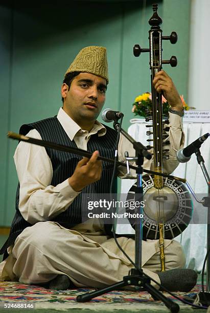 Kashmiri singer performs with the traditional musical instrument during a function organised by the Kashmir government during spring season on March...