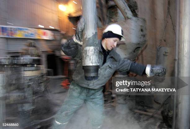 Worker changes pipes in the former Yukos and current Rosneft oil company drill platform in Priobskoye, western Siberia, 22 March 2005. Russian...