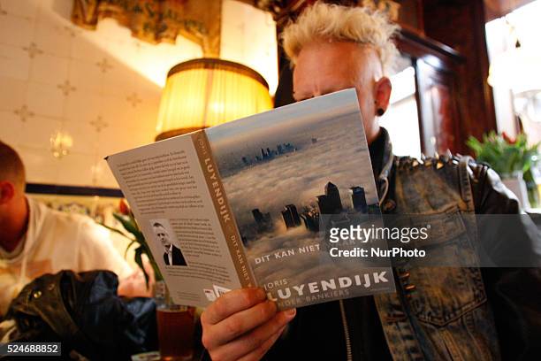 Man on April 30, 2015 in Leiden, Netherlands, is seen the recently released book by Dutch author Joris Luyendijk who spent three years interviewing...