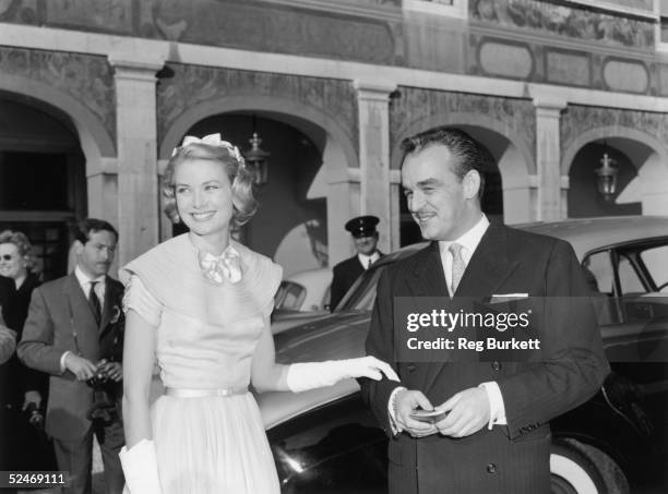 Prince Rainier of Monaco and his wife-to-be Princess Grace greet well-wishers in the palace courtyard in Monte Carlo prior to their wedding, 18th...
