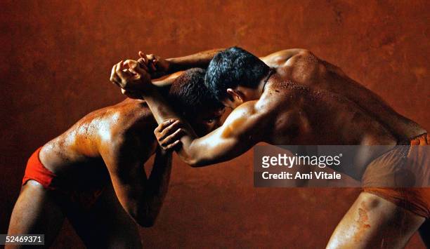 Indian men practice the three thousand year old sport known as "Kushti", a form of wrestling, in its traditional form at the fight club Shahupuri on...