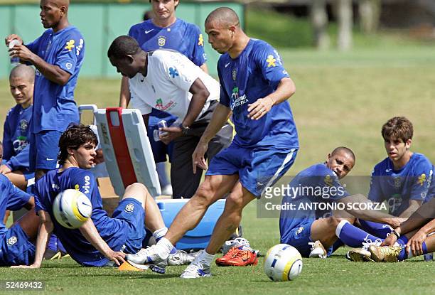 Brazilian soccer striker Ronaldo Nazario kicks the ball as teammates Kaka, Roberto Carlos and Juninho Pernambucano watch him during a training...