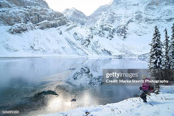 partially frozen lake - canmore alberta stock pictures, royalty-free photos & images