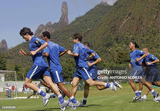 Brazilian soccer players Ricardo Leite, known as Kaka , Ronaldinho Gaucho and Juninho Pernambucano , run with other players during a training session...