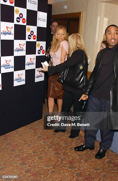 Singer Mariah Carey walks to the Awards Room with the award for outstanding contribution to music at the Capital FM Awards 2005 at the Royal...