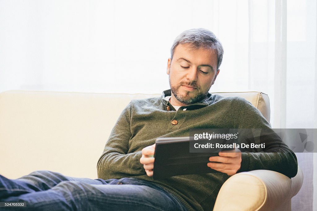 Man Working On A Tablet At Home