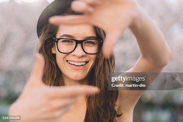 young girl hand framing - eyeglass frames stock pictures, royalty-free photos & images