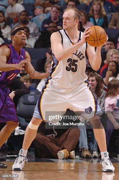 Brian Cardinal of the Memphis Grizzlies looks to move the ball against Rafer Alston of the Toronto Raptors during the game at FedexForum on March 4,...