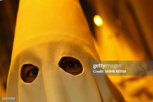 Penitent walks during a "Santo Cristo de la Santa Cruz" procession in Palma de Mallorca, late 23 March 2005. The Catholic Church on Sunday began...