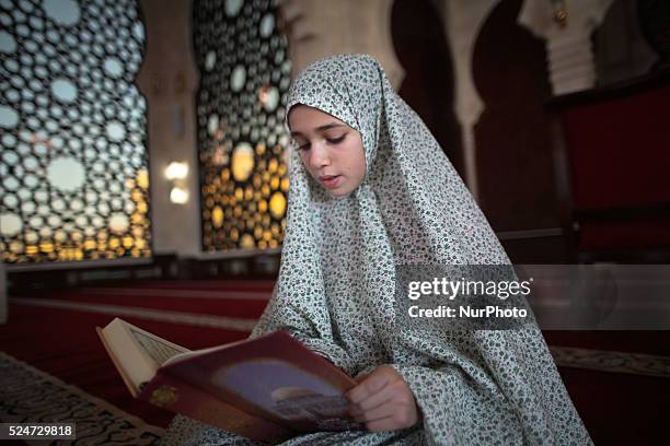 Palestinian girl, Asmaa Ouda, reads Quran at al-khaldi mosque on the Muslim fasting month of Ramadan in Gaza City, Ramadan is the holiest month in...