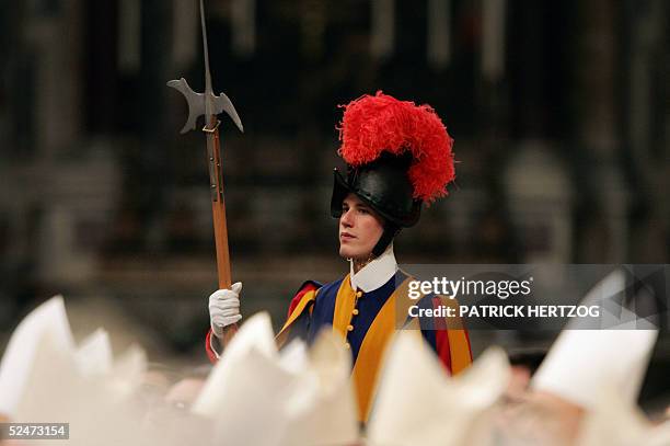 Swiss guard stands behind cardinals during the 'Mass of the Chrism' in St Peter's Basilica at the Vatican, 24 March 2005. A frail Pope John Paul II...