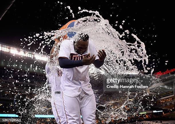 Oswaldo Arcia of the Minnesota Twins pours water on teammate Miguel Sano after Sano hit a walk-off single against the Cleveland Indians during the...