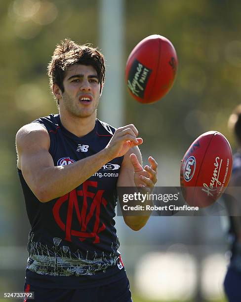 Christian Petracca of the Demons handballs during a Melbourne Demons AFL training session at Goschs Paddock on April 27, 2016 in Melbourne, Australia.