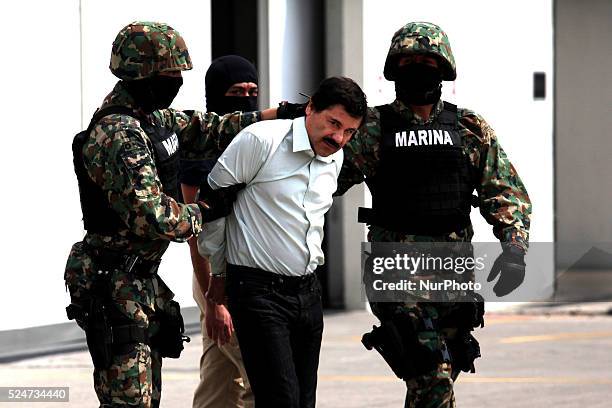 Mexican Navy soldiers escort Joaquin Guzman Loera , alias "El Chapo Guzman", leader of the Sinaloa Cartel, during his show up in front of the press,...