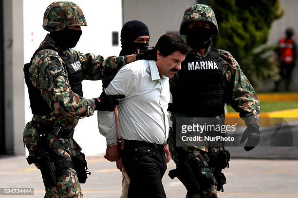 Mexican Navy soldiers escort Joaquin Guzman Loera , alias "El Chapo Guzman", leader of the Sinaloa Cartel, during his show up in front of the press,...