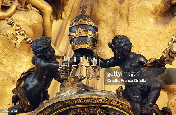 Sculpture showing two angels holding the Pope's tiara and the St. Peter's keys are seen in St. Peter's Basilica during the Chrism Mass celebration at...