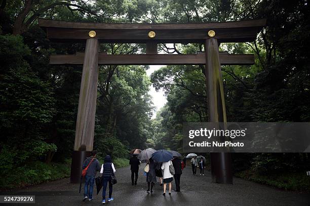 People pass through the main gate to Meiji Shrine in Tokyo on October17, 2015. Meiji Shrine, located in Shibuya, Tokyo, is the Shinto shrine that is...