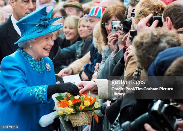 Queen Elizabeth II meets the public and receives gifts of flowers during a walkabout after the traditional Maundy Service on March 24, 2005 in...