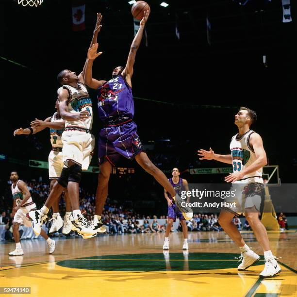Marcus Camby of the Toronto Raptors drives to the basket for a shot against the Vancouver Grizzlies on October 27, 1996 during an NBA game in...