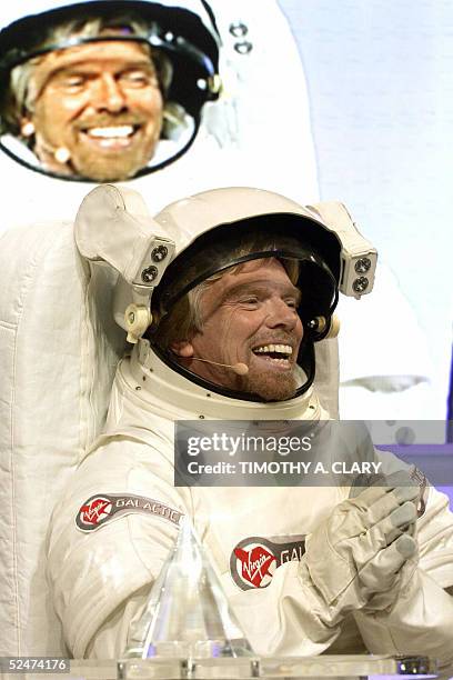Virgin Atlantic Founder Richard Branson wearing a spacesuit announces the winner of his Virgin Galatic Sub-Orbital flight, during a press conference...