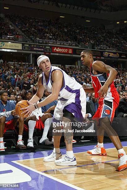 Mike Bibby of the Sacramento Kings is defended by Jason Hart of the Charlotte Bobcats during the game at the Arco Arena on December 7, 2004 in...